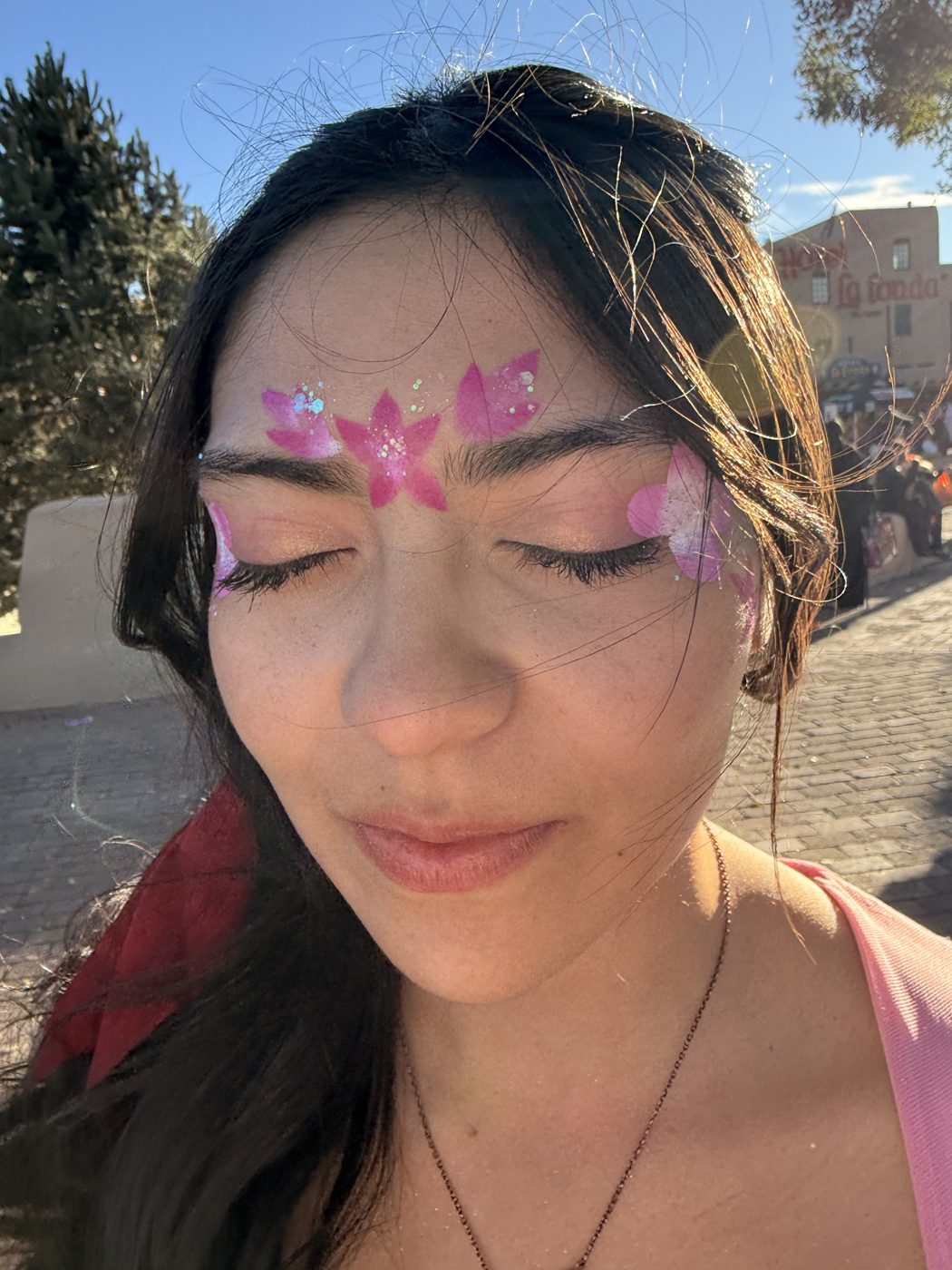 Pink lotus flower face paint with glitter