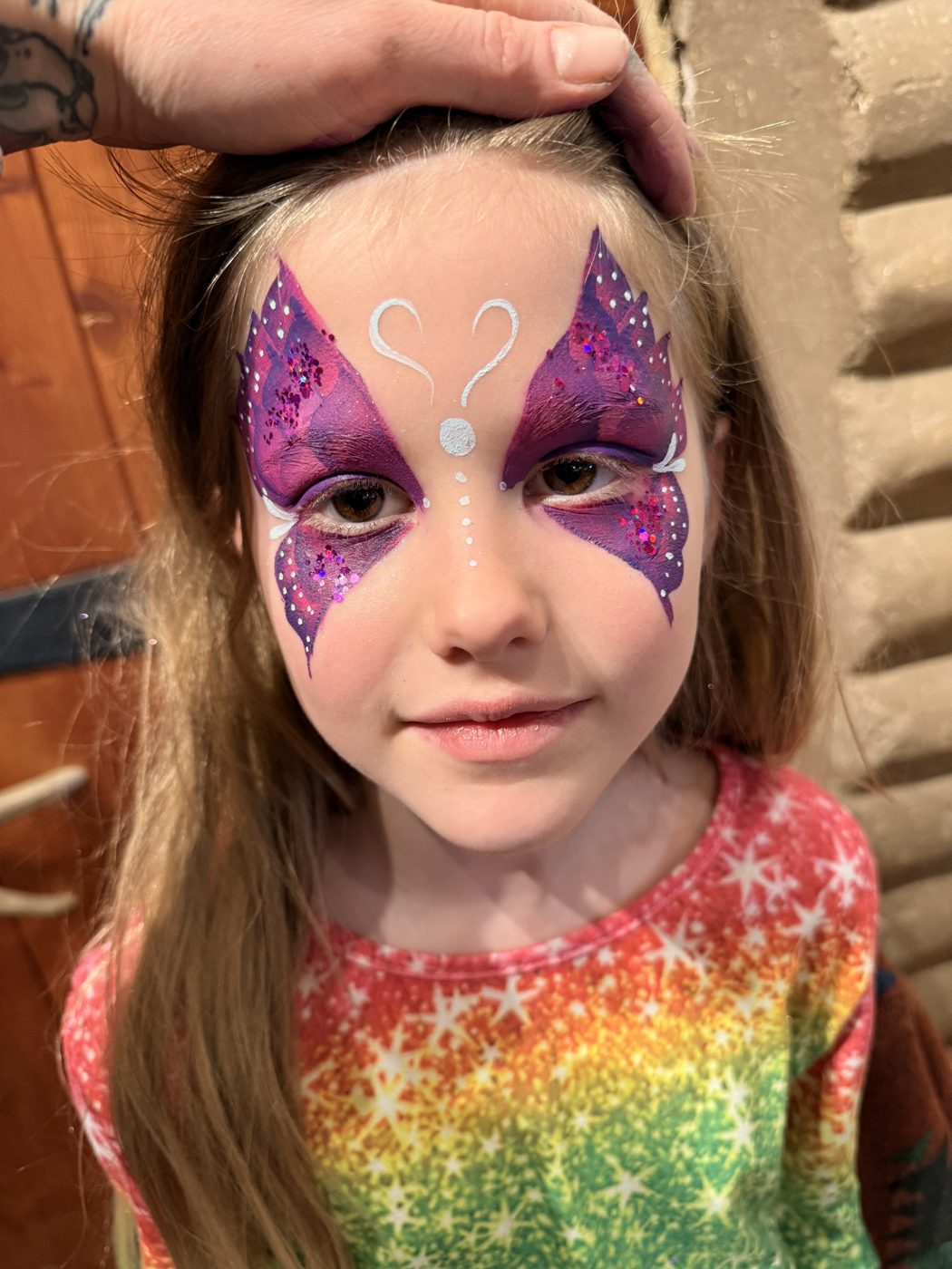 Sparkling purple butterfly face paint
